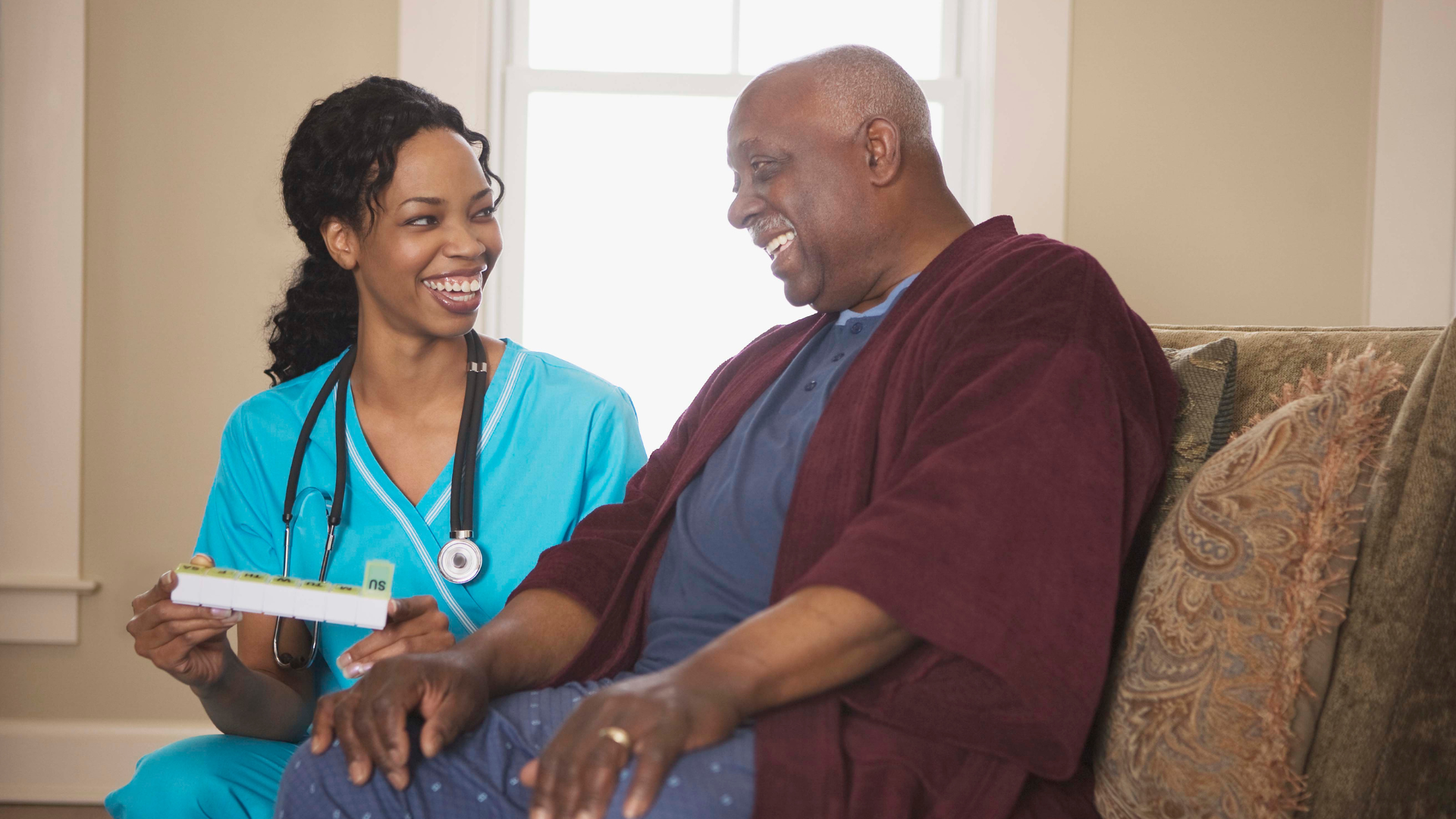 Healthcare staff happily assists a resident with medication pass in long-term care