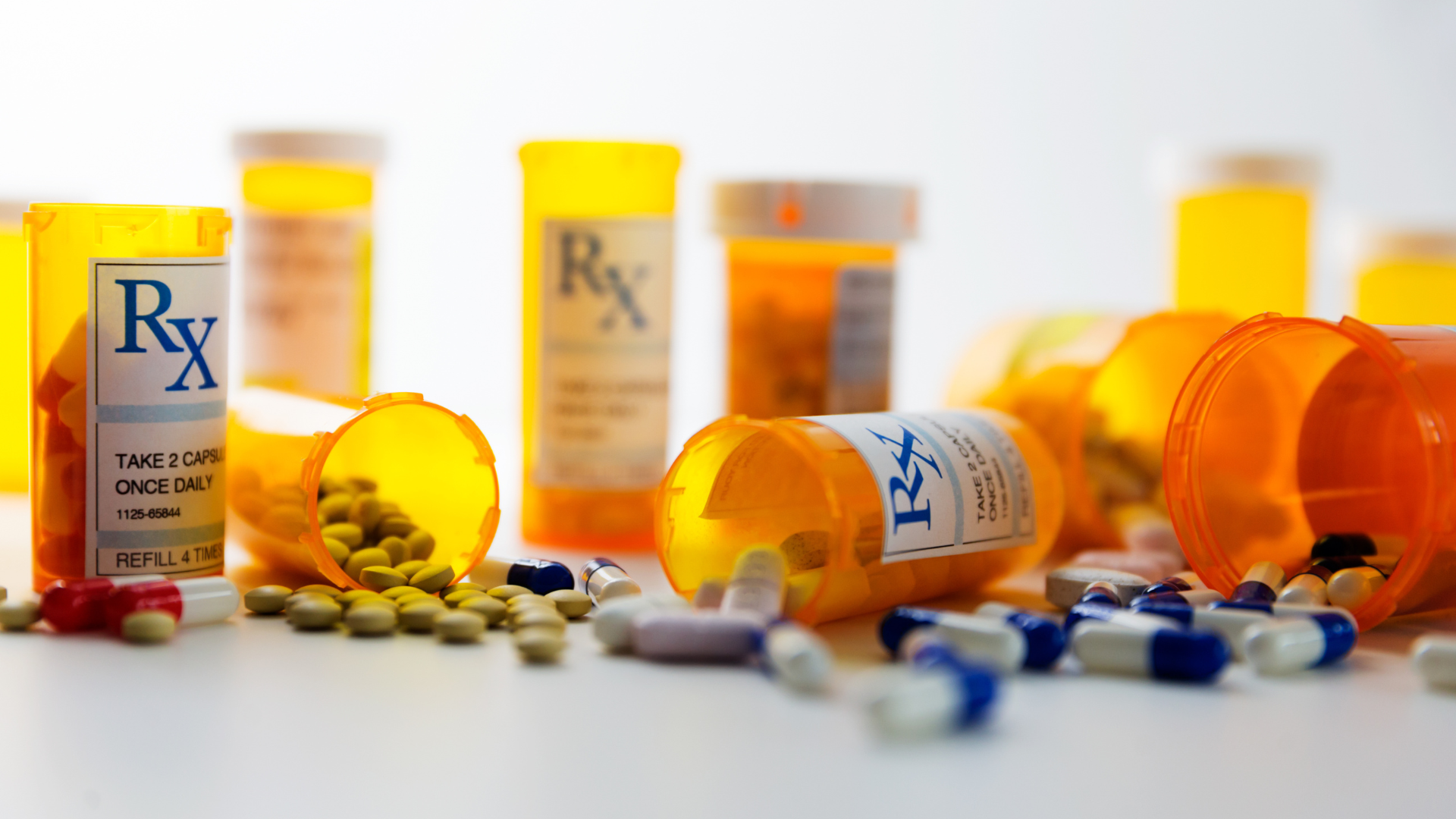 A messy mix of pills and pill bottles that require cleaning and medication waste management